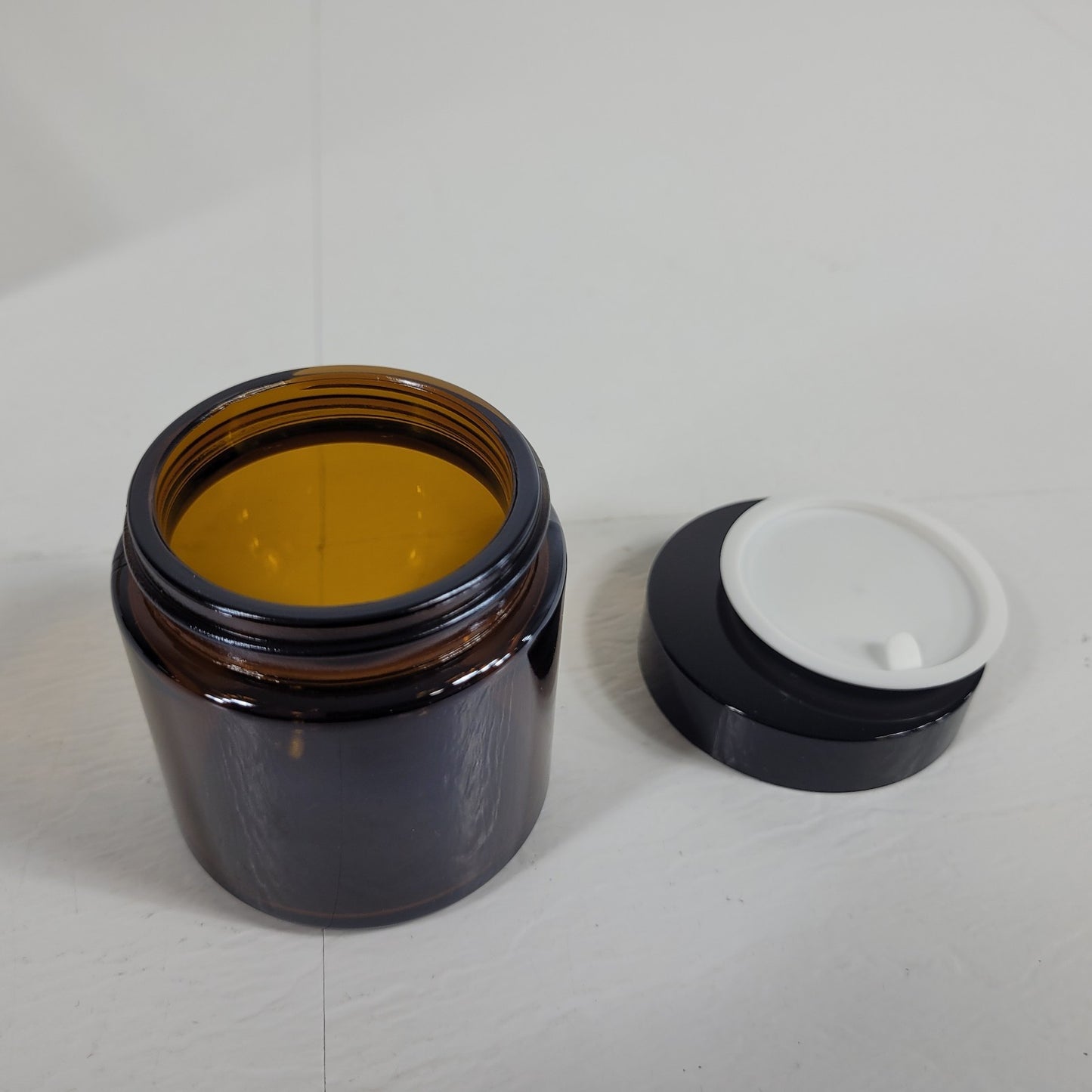Vivaplex Amber 4 Oz Round Glass Jars with Inner Liners and Black Lids - 12 Pack