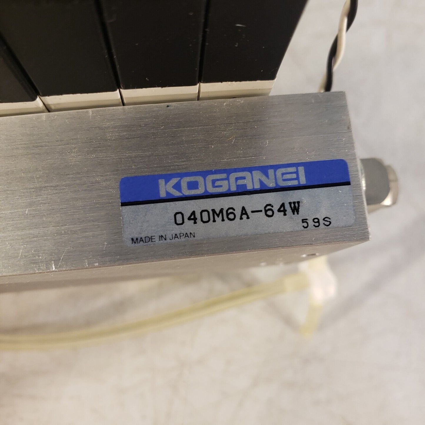 Koganei 040M6A-64W Manifold Block with (7) A040-4E1-37W Solenoid Valves 0.3MPa